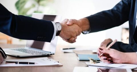 Business people shaking hands, finishing up a meeting.
